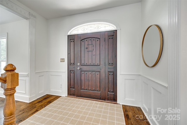 7122 Forest Ridge Rd, Matthews, NC 28104 - foyer entrance featuring dark wood finished floors, wainscoting, and a decorative wall