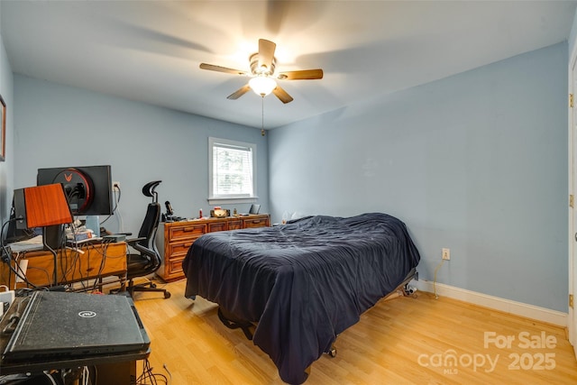 7122 Forest Ridge Rd, Matthews, NC 28104 - bedroom with light wood-style floors, a ceiling fan, and baseboards