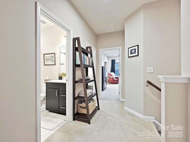 12641 Glowing Peak Rd, Huntersville, NC 28078 - hall featuring baseboards, visible vents, light carpet, and an upstairs landing