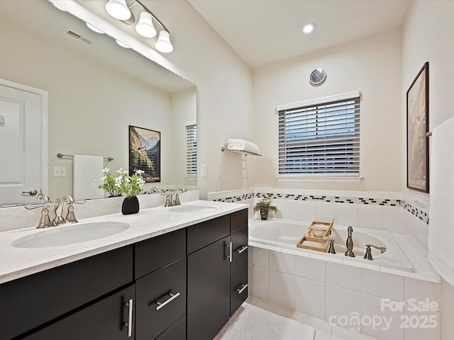 12641 Glowing Peak Rd, Huntersville, NC 28078 - bathroom with double vanity, visible vents, a sink, and a bath