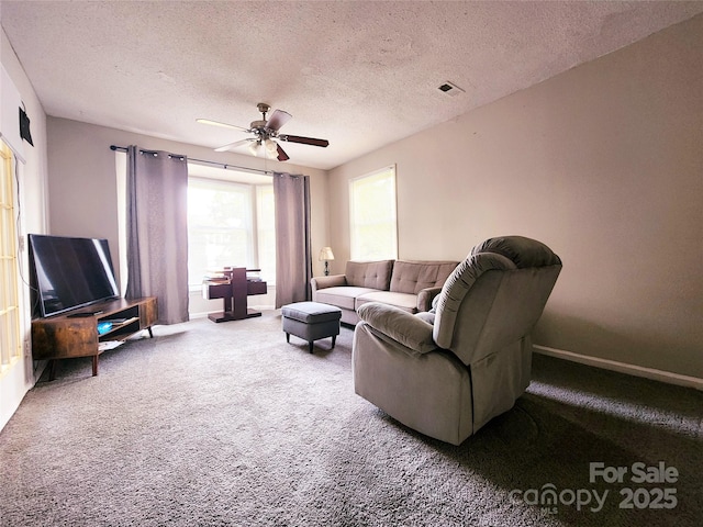 6234 Rosecroft Dr, Charlotte, NC 28215 - carpeted living area featuring a textured ceiling, visible vents, a ceiling fan, and baseboards