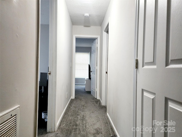 6234 Rosecroft Dr, Charlotte, NC 28215 - corridor with baseboards, heating unit, a textured ceiling, and carpet