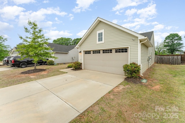 traditional home featuring a front yard, concrete driveway, a garage, and fence