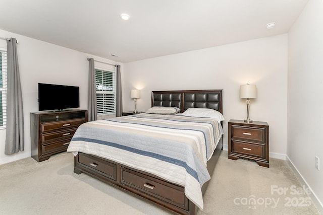 bedroom with recessed lighting, multiple windows, light carpet, and baseboards