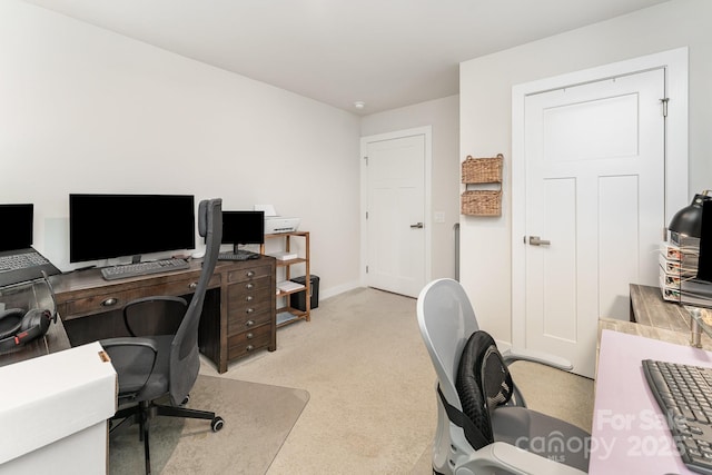 office featuring baseboards and light colored carpet
