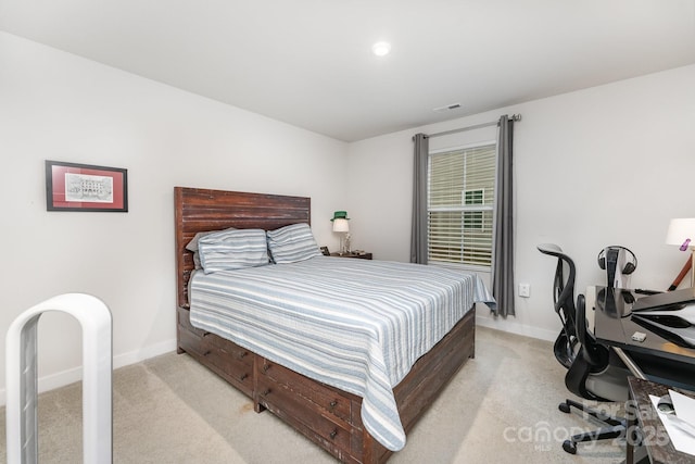 bedroom featuring baseboards, visible vents, and light carpet