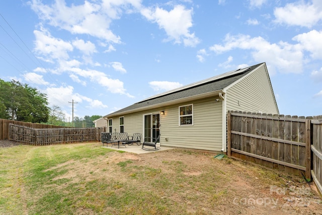 back of property featuring a patio, a fenced backyard, and a lawn