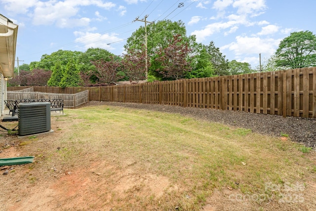 view of yard featuring a fenced backyard and central AC unit