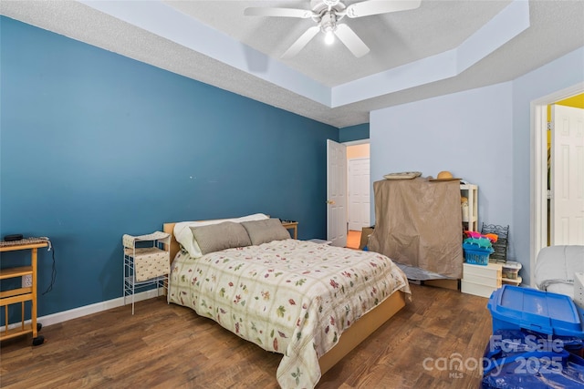 11913 Little Stoney Ct, Charlotte, NC 28269 - bedroom with baseboards, a raised ceiling, ceiling fan, and wood finished floors