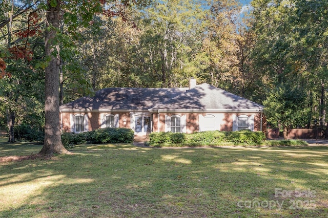2643 Rolling Hills Dr, Monroe, NC 28110 - ranch-style home featuring a front lawn, a chimney, and brick siding