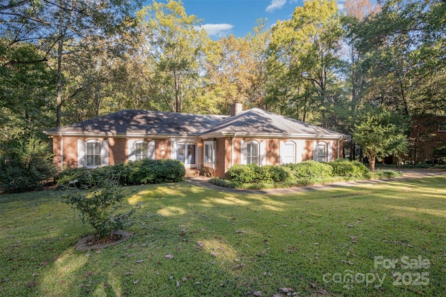 2643 Rolling Hills Dr, Monroe, NC 28110 - single story home with a front lawn, brick siding, and a chimney