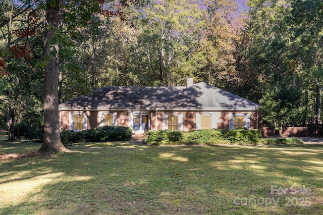 2643 Rolling Hills Dr, Monroe, NC 28110 - ranch-style house with a chimney, a front lawn, and brick siding