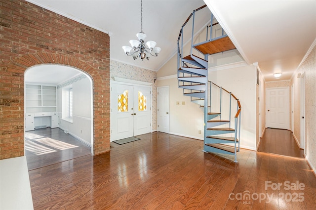 2643 Rolling Hills Dr, Monroe, NC 28110 - foyer entrance with stairway, wood finished floors, arched walkways, baseboards, and a notable chandelier