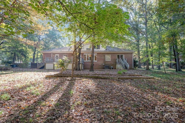 2643 Rolling Hills Dr, Monroe, NC 28110 - rear view of property with brick siding, stairs, and central AC unit