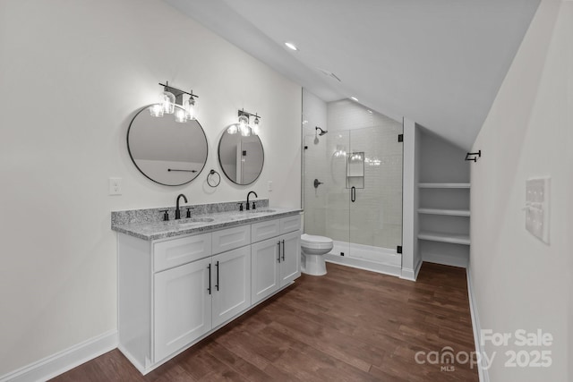 4034 Daugherty Rd, China Grove, NC 28023 - bathroom with vaulted ceiling, double vanity, a shower stall, wood finished floors, and recessed lighting