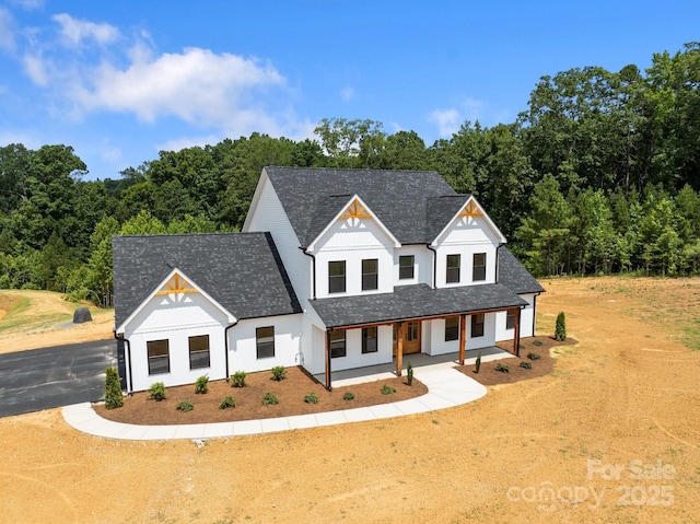 4034 Daugherty Rd, China Grove, NC 28023 - modern farmhouse style home featuring board and batten siding, driveway, a porch, and roof with shingles