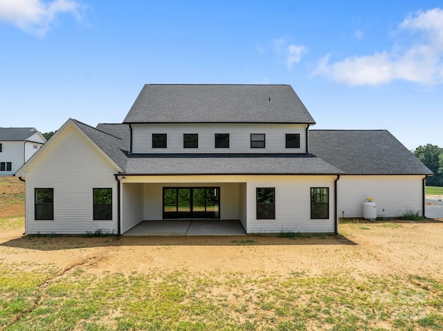 4034 Daugherty Rd, China Grove, NC 28023 - rear view of house with a patio area, a shingled roof, and a lawn