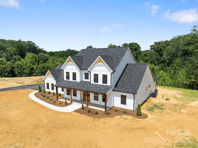 4034 Daugherty Rd, China Grove, NC 28023 - modern farmhouse with driveway, board and batten siding, a porch, a view of trees, and roof with shingles