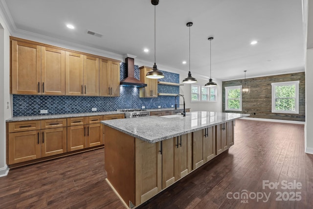 4034 Daugherty Rd, China Grove, NC 28023 - kitchen with wall chimney exhaust hood, a center island with sink, tasteful backsplash, dark wood finished floors, and light stone counters