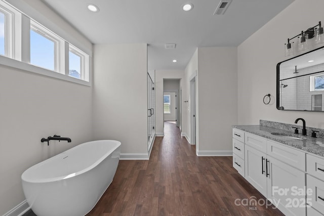 4034 Daugherty Rd, China Grove, NC 28023 - full bath with a stall shower, vanity, a freestanding bath, wood finished floors, and recessed lighting