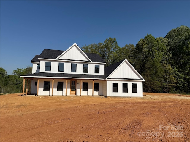 view of front of property featuring roof with shingles and a porch