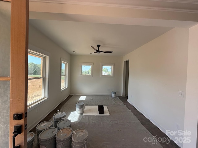 interior space with baseboards and ceiling fan