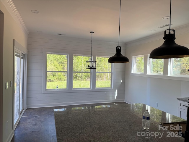 unfurnished dining area with visible vents, dark wood finished floors, and crown molding