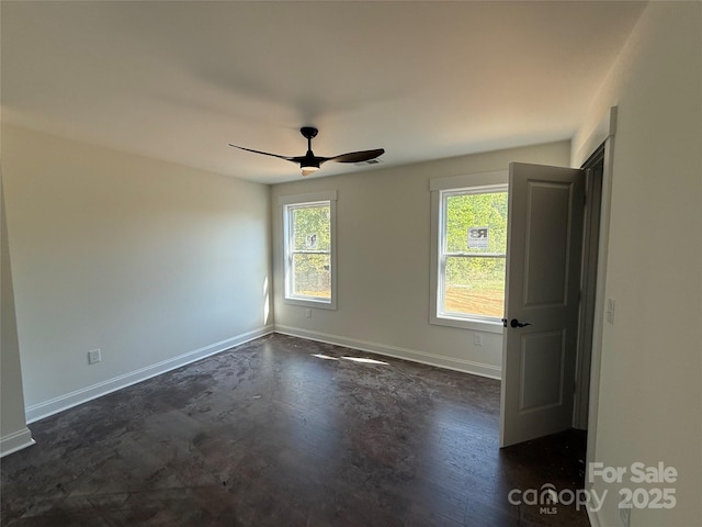unfurnished room featuring visible vents, baseboards, and ceiling fan