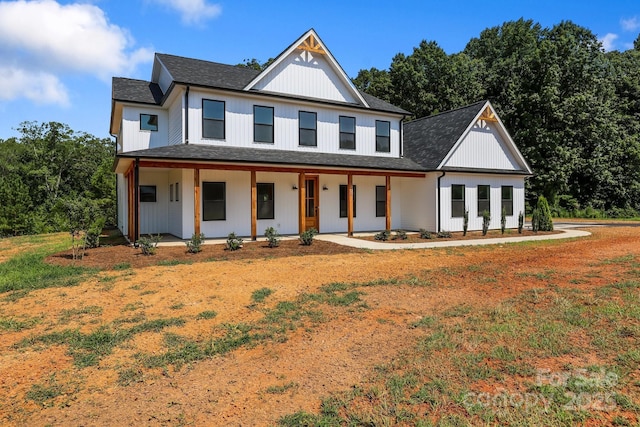 4040 Daugherty Rd, China Grove, NC 28023 - modern farmhouse style home featuring covered porch, a shingled roof, and a front lawn