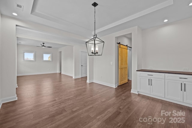 4040 Daugherty Rd, China Grove, NC 28023 - unfurnished dining area featuring a barn door, a tray ceiling, dark wood finished floors, recessed lighting, and a ceiling fan