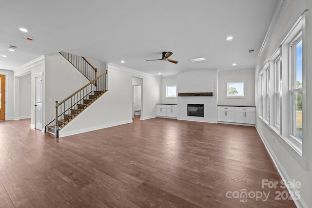 4040 Daugherty Rd, China Grove, NC 28023 - unfurnished living room featuring crown molding, stairway, a ceiling fan, a fireplace, and recessed lighting