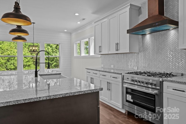 4040 Daugherty Rd, China Grove, NC 28023 - kitchen featuring stainless steel range, wall chimney exhaust hood, tasteful backsplash, dark wood finished floors, and light stone counters