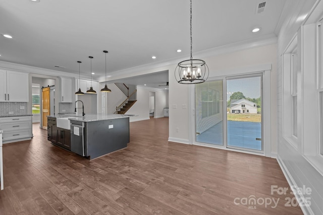 4040 Daugherty Rd, China Grove, NC 28023 - kitchen with stainless steel dishwasher, crown molding, open floor plan, recessed lighting, and light stone counters