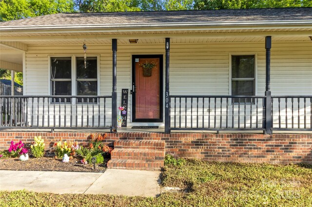 304 W Fourth St, Cherryville, NC 28021 - entrance to property with a shingled roof and covered porch