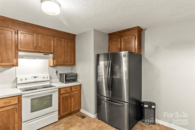 304 W Fourth St, Cherryville, NC 28021 - kitchen featuring white electric range, under cabinet range hood, light countertops, freestanding refrigerator, and brown cabinetry