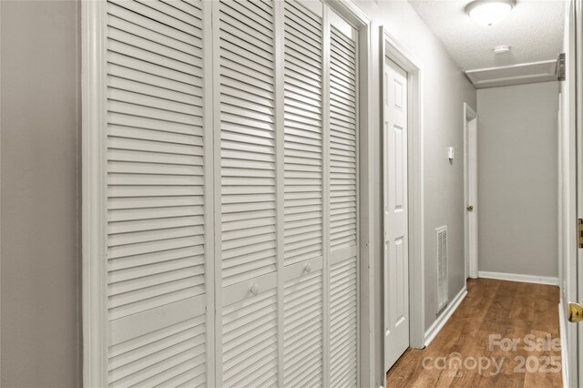 304 W Fourth St, Cherryville, NC 28021 - corridor featuring baseboards, wood finished floors, visible vents, and a textured ceiling