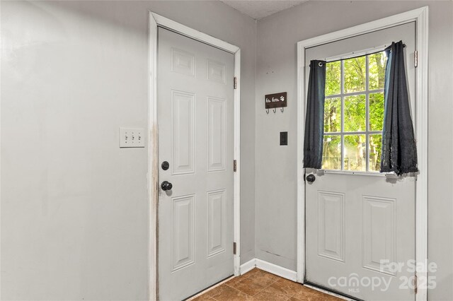 304 W Fourth St, Cherryville, NC 28021 - doorway to outside featuring baseboards
