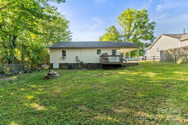 304 W Fourth St, Cherryville, NC 28021 - back of property featuring a wooden deck, crawl space, a fenced backyard, and an outdoor fire pit