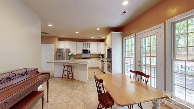 dining area featuring recessed lighting, visible vents, and light tile patterned floors