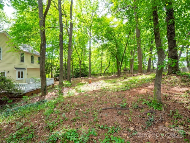view of yard with fence and a deck
