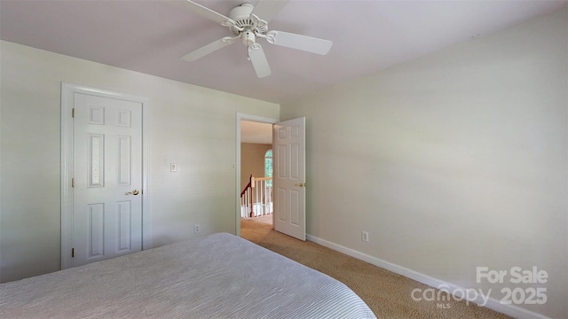 bedroom with baseboards, light colored carpet, and ceiling fan