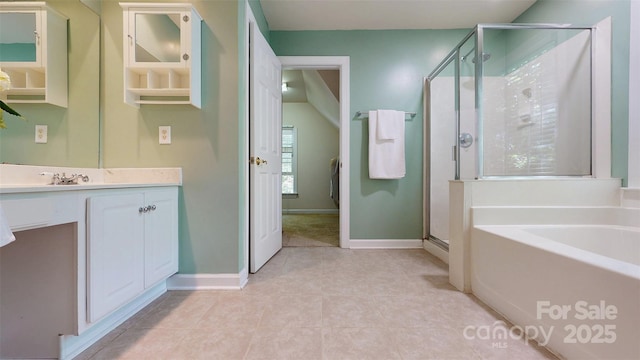 bathroom featuring baseboards, a shower stall, a bath, and vanity