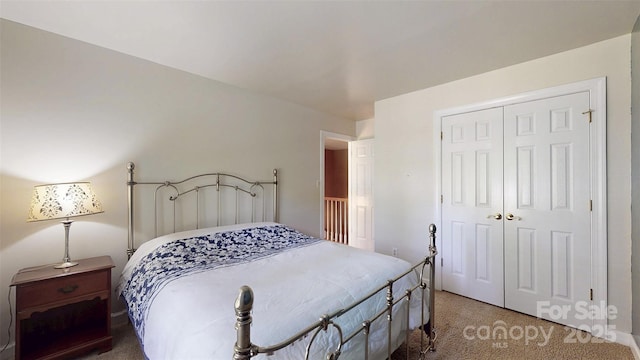 bedroom featuring a closet and light colored carpet