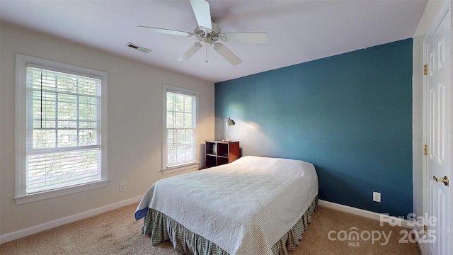 carpeted bedroom featuring ceiling fan, baseboards, and visible vents