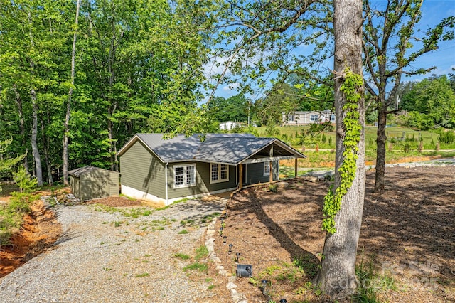 115 Cold Springs Dr, Mill Spring, NC 28756 - view of front of home featuring gravel driveway, a shed, an outdoor structure, and french doors