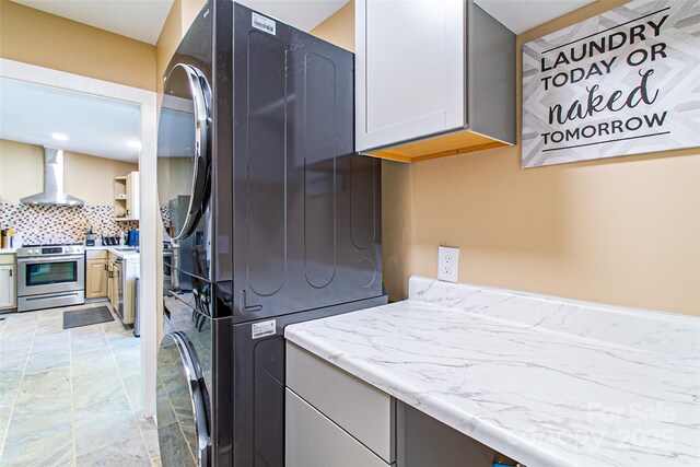 115 Cold Springs Dr, Mill Spring, NC 28756 - clothes washing area featuring stacked washer / drying machine and cabinet space