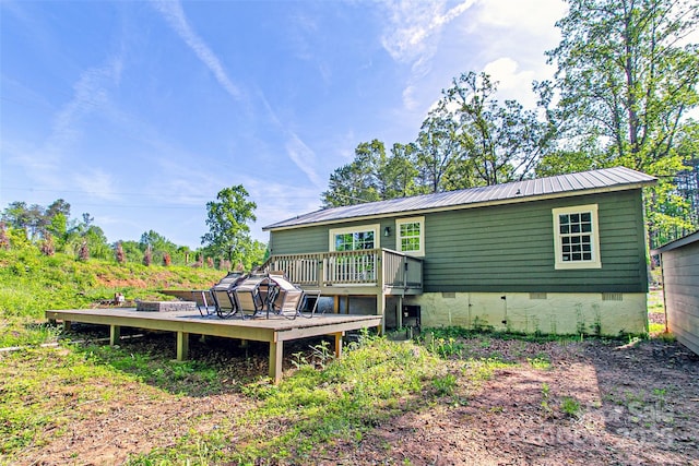 115 Cold Springs Dr, Mill Spring, NC 28756 - rear view of property with crawl space, a wooden deck, and metal roof