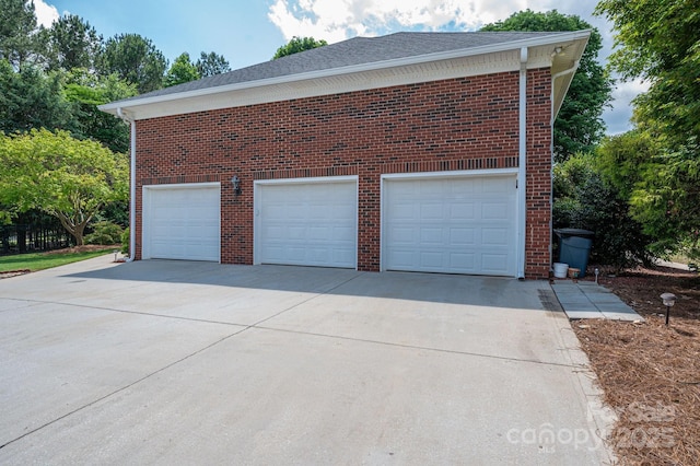 garage featuring concrete driveway
