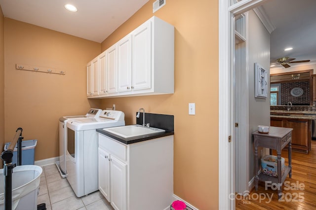 clothes washing area with washer and clothes dryer, cabinet space, recessed lighting, ceiling fan, and baseboards
