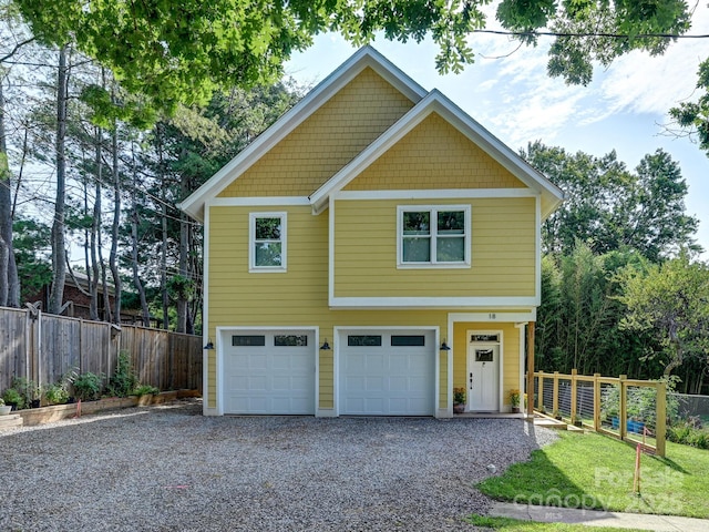 18 Covington St, Asheville, NC 28806 - view of front of house featuring an attached garage, gravel driveway, and fence